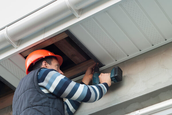 Installation of soffits by roofing contractor.