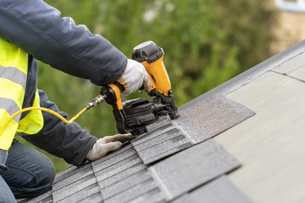 Roofing professional working on roof installation.