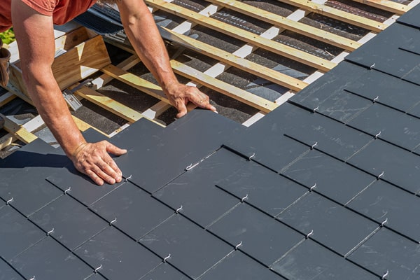 Slate roof installation by a roofing contractor.